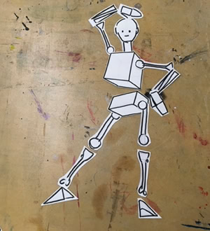 Découpage en papier d'une figure humaine stylisée avec des formes géométriques sur une table en bois.