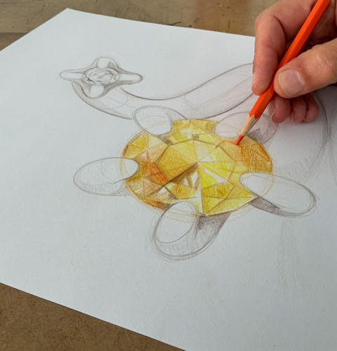 Bijou en forme de fleur avec une tige violette, une fleur rouge et une verte.