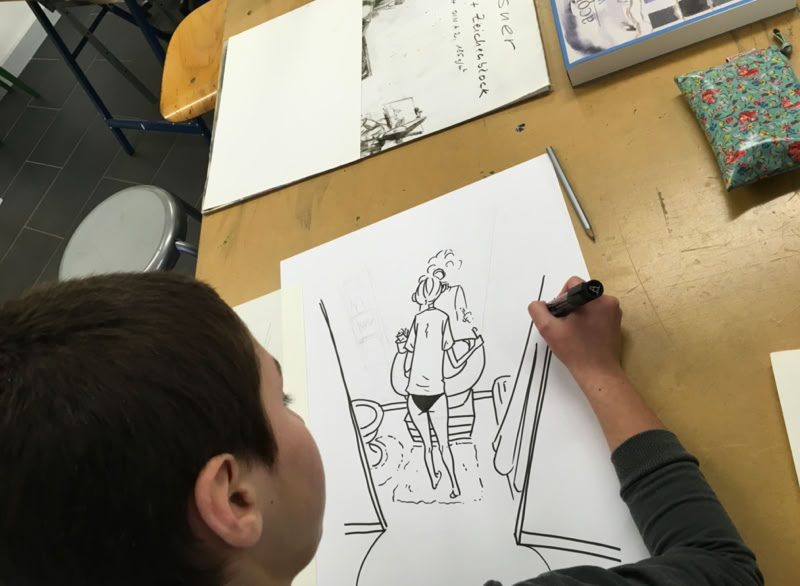 Un enfant dessine sur une feuille de papier, avec un dessin en noir et blanc représentant une personne marchant.